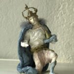 a second king is kneeing on his nee among the other nativity characters