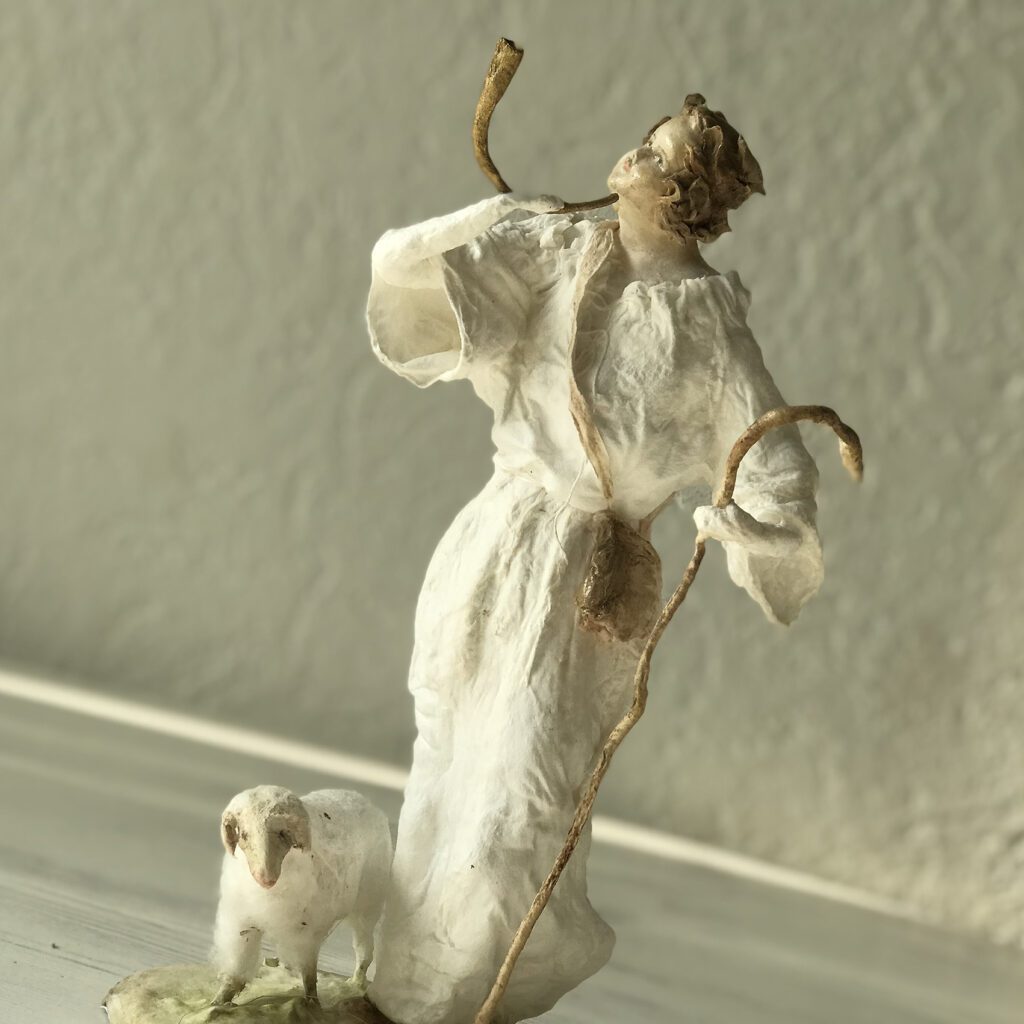 one of the shepherd is calling melodically and holding his horn beside his sheep