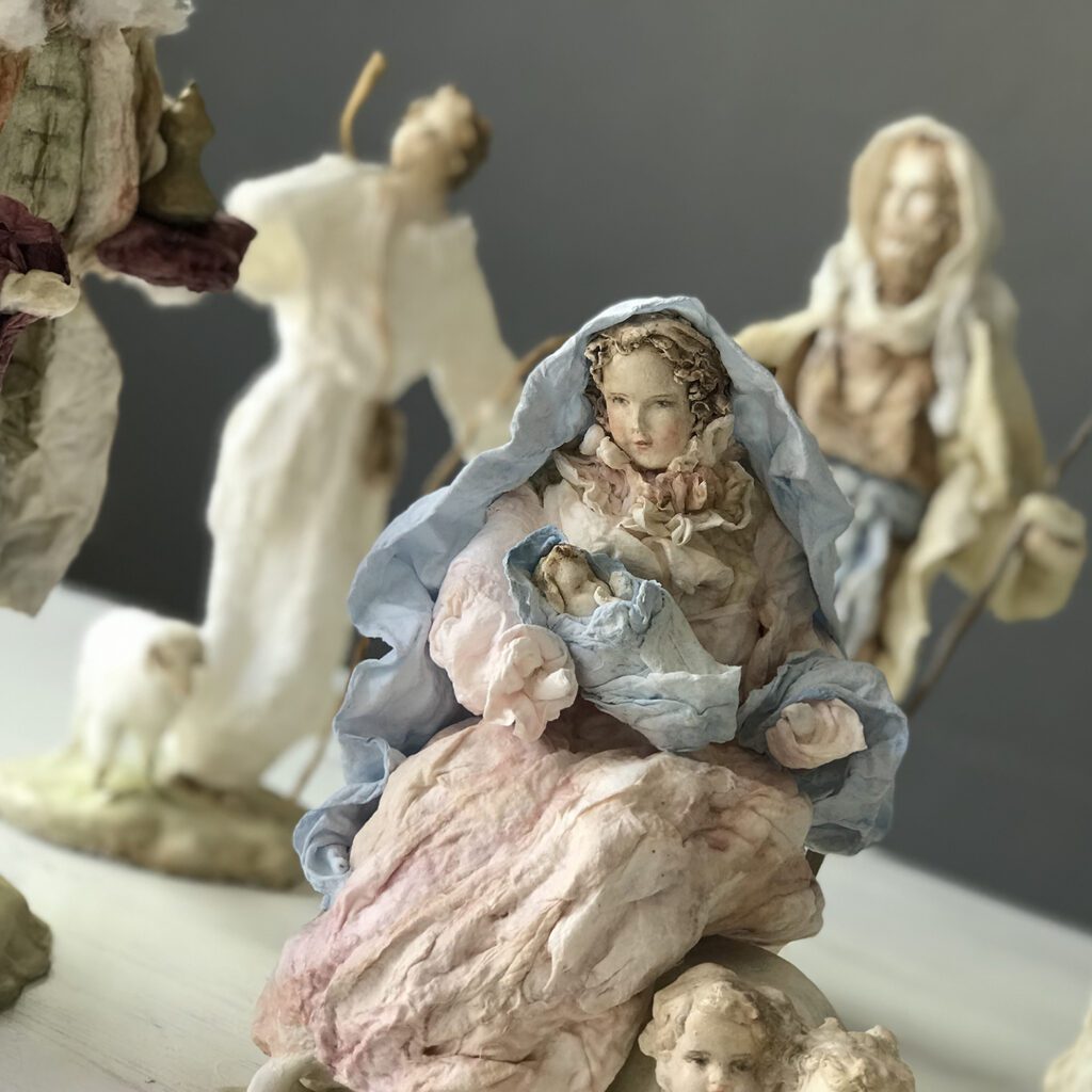 Maria carries Jesus on her lap