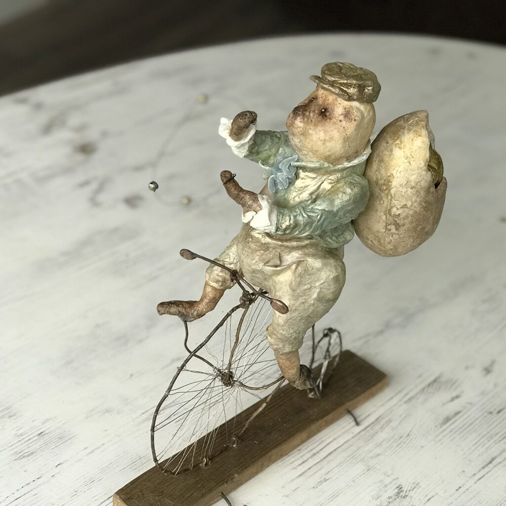 Agoo is juggling the balls on his penny-farthing