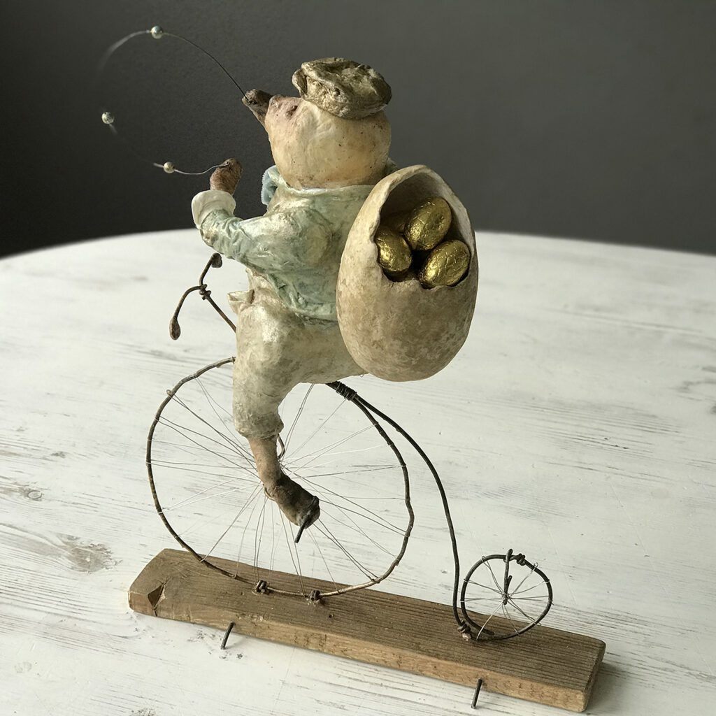 Agoo is playing on his penny-farthing in the carnival