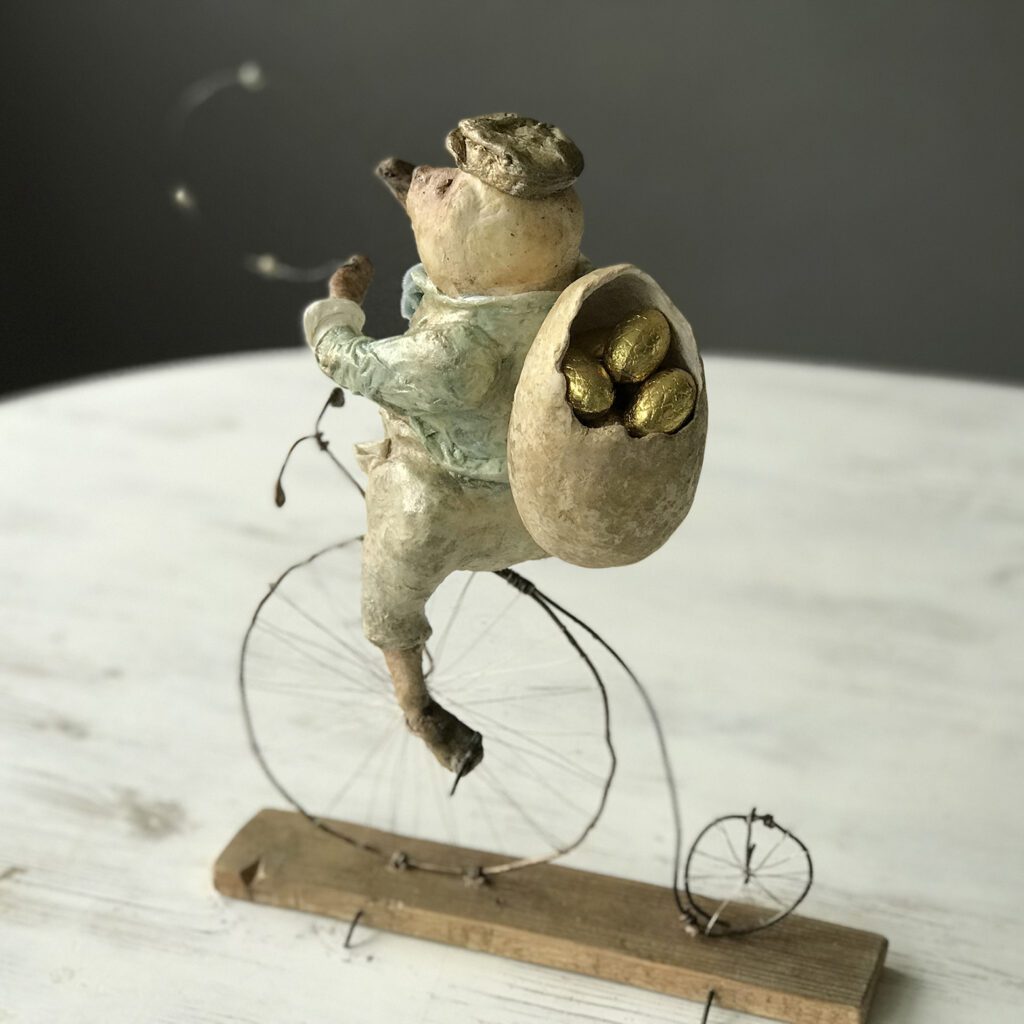 Agoo is playing on his penny-farthing